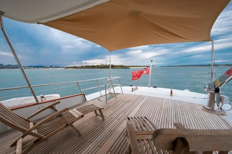 Atlantic Princess Yacht Photos Pics Deck view of 1992 GeTa 86ft Motor Yacht with ocean backdrop and lounge chairs.