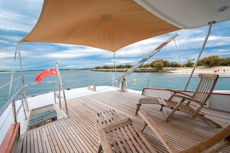 Atlantic Princess Yacht Photos Pics Custom GeTa 86ft Motor Yacht deck with chairs, canopy, and scenic ocean view, 1992 model.