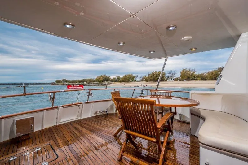 Atlantic Princess Yacht Photos Pics Luxurious deck of 1992 GeTa 86ft Motor Yacht with wooden seating and ocean view.