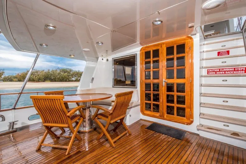 Atlantic Princess Yacht Photos Pics Luxurious 1992 GeTa 86ft Motor Yacht deck with wooden furniture and elegant design.