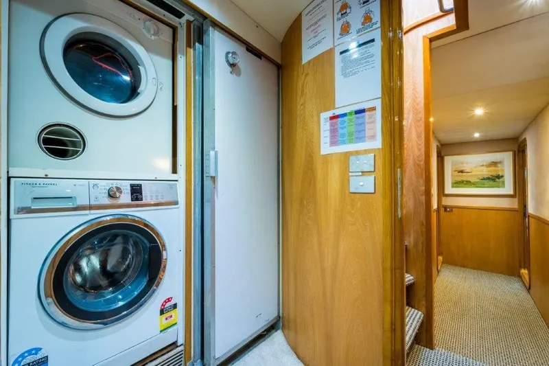 Atlantic Princess Yacht Photos Pics Laundry area in 1992 GeTa 86ft Motor Yacht with washer, dryer, and hallway view.