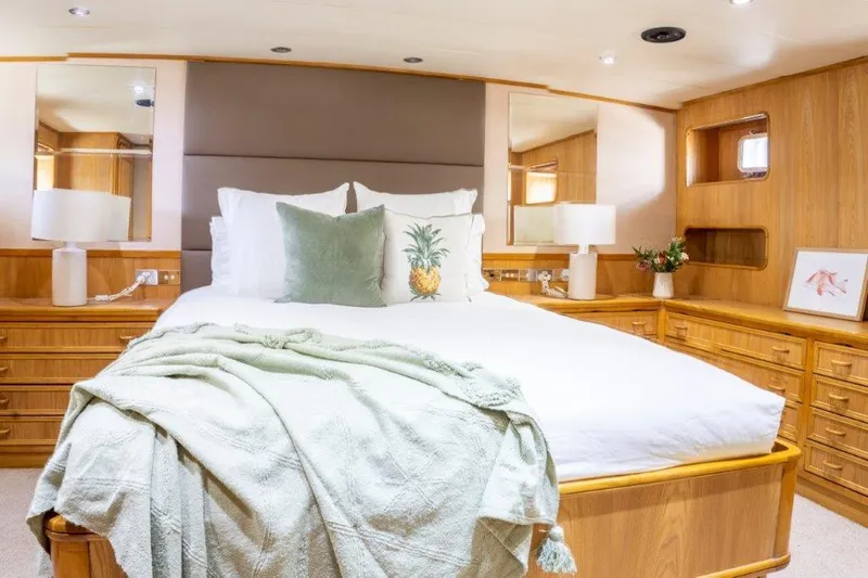 Atlantic Princess Yacht Photos Pics Luxurious bedroom on 1992 Custom GeTa 86ft Motor Yacht with elegant decor and cozy bedding.