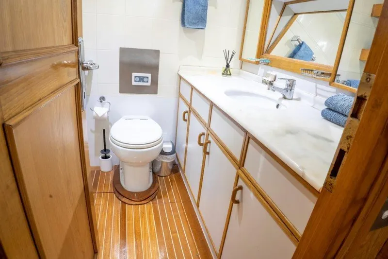 Atlantic Princess Yacht Photos Pics Luxurious bathroom on 1992 GeTa 86ft Motor Yacht with wooden flooring and modern amenities.