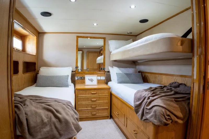 Atlantic Princess Yacht Photos Pics Cozy cabin interior of 1992 GeTa 86ft Motor Yacht with twin beds and wooden furnishings.
