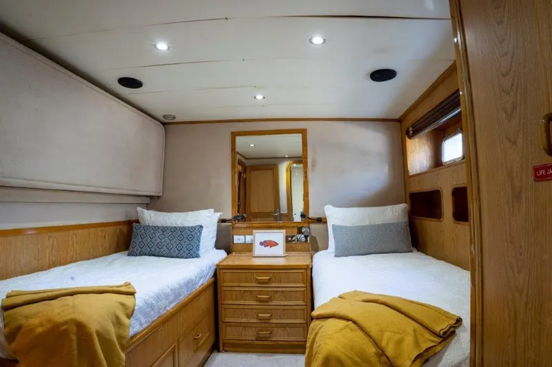 Atlantic Princess Yacht Photos Pics Twin cabin interior of 1992 Custom GeTa 86ft Motor Yacht with cozy beds and wooden decor.