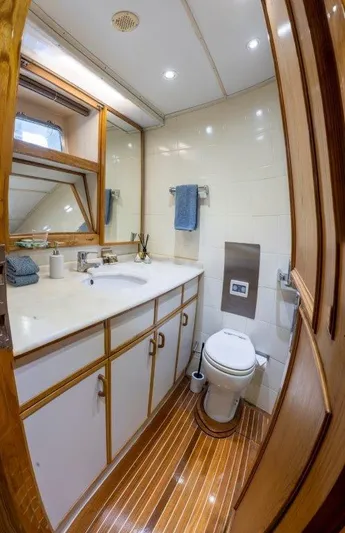 Atlantic Princess Yacht Photos Pics Luxurious bathroom on 1992 Custom GeTa 86ft Motor Yacht with wood accents and modern fixtures.