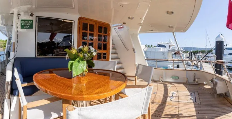 Atlantic Princess Yacht Photos Pics Outdoor deck of 1992 Custom GeTa 86ft Motor Yacht with elegant seating and table.