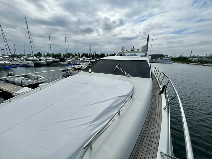  Yacht Photos Pics Luxurious 2011 Azimut 62S Italia yacht docked in a marina under cloudy skies.