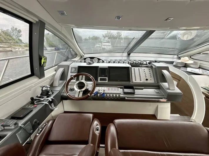  Yacht Photos Pics Interior cockpit of 2011 Azimut 62S Italia yacht with modern controls and leather seating.