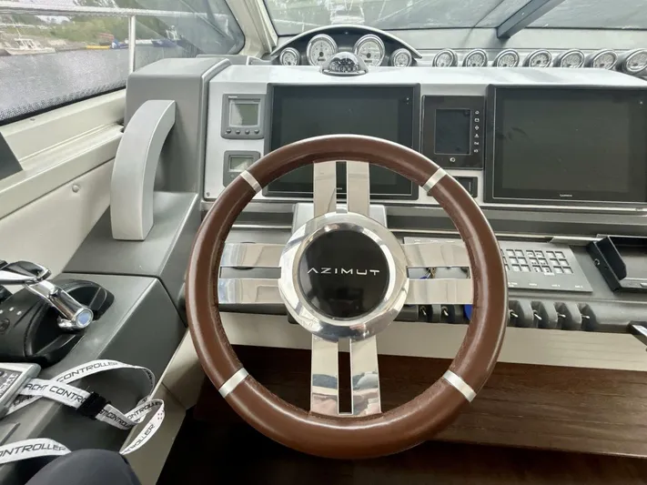  Yacht Photos Pics Steering wheel of 2011 Azimut 62S Italia yacht with modern dashboard controls.