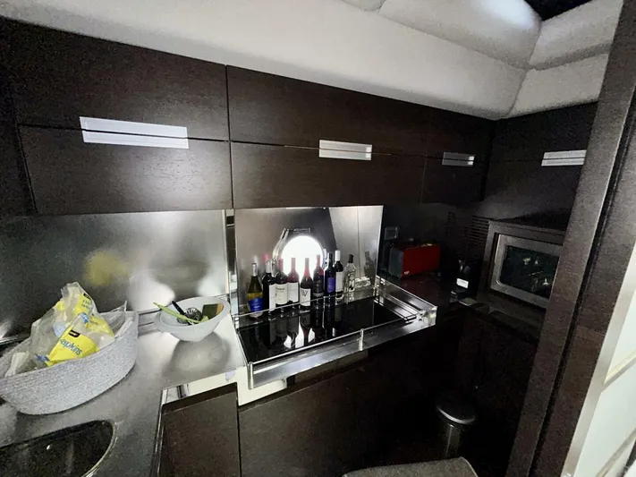  Yacht Photos Pics Luxurious kitchen interior of 2011 Azimut 62S Italia yacht with modern cabinetry and appliances.