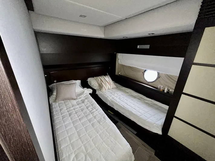  Yacht Photos Pics Twin bedroom in 2011 Azimut 62S Italia yacht, featuring modern design and porthole window.