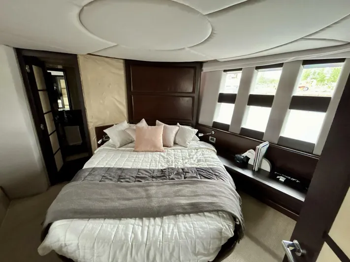  Yacht Photos Pics Luxurious bedroom interior of 2011 Azimut 62S Italia yacht with modern design and large windows.