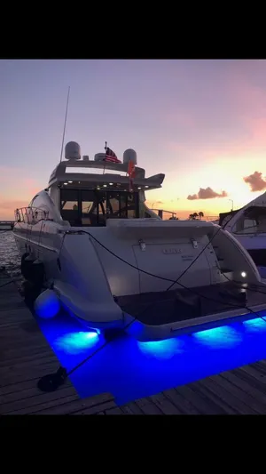  Yacht Photos Pics 2011 Azimut 62S Italia yacht docked at sunset with blue underwater lights.