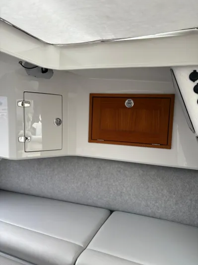  Yacht Photos Pics Interior of 2020 Protector 310 Targa boat with storage compartments and seating.