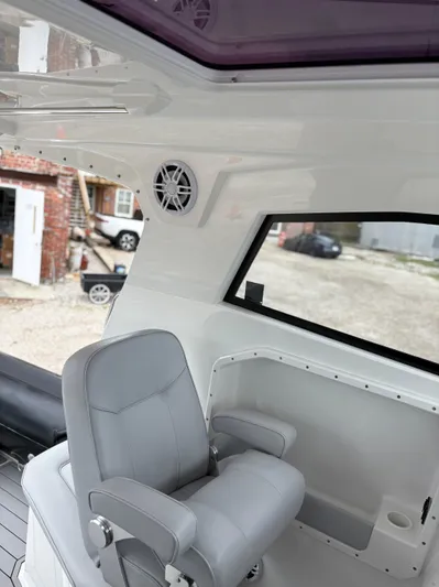  Yacht Photos Pics Interior of 2020 Protector 310 Targa boat with gray seating and speaker.