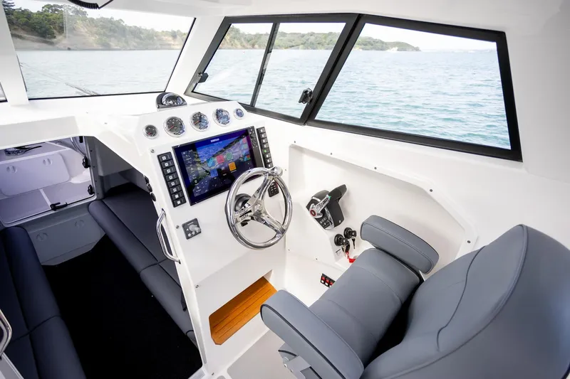 Yacht Photos Pics Interior of 2020 Protector 310 Targa boat with modern dashboard and steering.