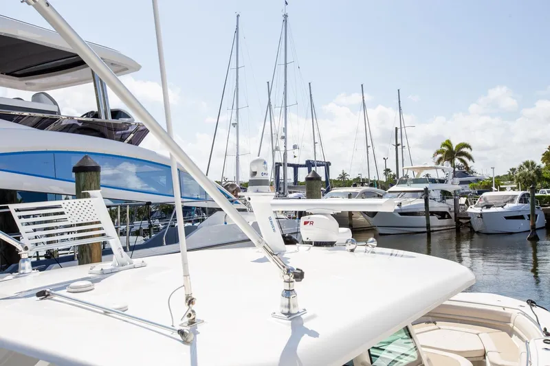  Yacht Photos Pics 2019 Boston Whaler 380 Outrage docked among luxury yachts in a sunny marina.