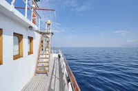 Historic 1902 Ailsa Shipbuilding vessel on calm sea under clear blue sky.