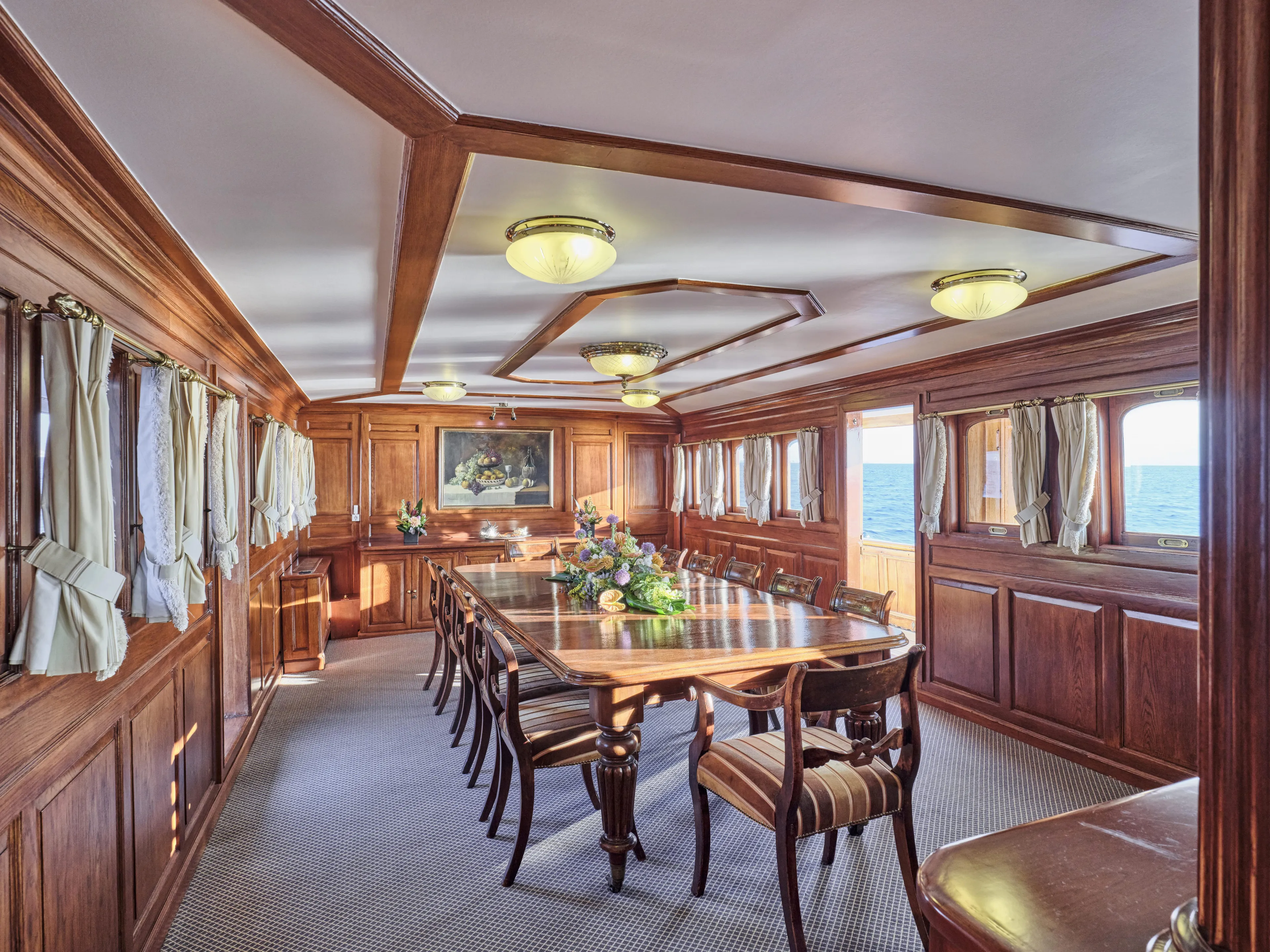Luxurious vintage ship dining room with elegant wood paneling and ocean view, Ailsa Shipbuilding 1902.