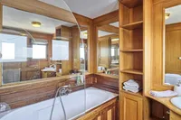 Luxurious wooden bathroom interior on a 1902 Ailsa Shipbuilding custom vessel.