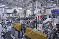 Engine room of a 1902 Custom Ailsa Shipbuilding vessel, showcasing machinery and control panels.