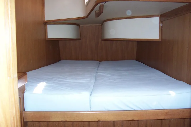 Blue Yacht Photos Pics Cozy cabin interior of 1994 C&C 51 XL C/B sailboat with wooden finish and double bed.