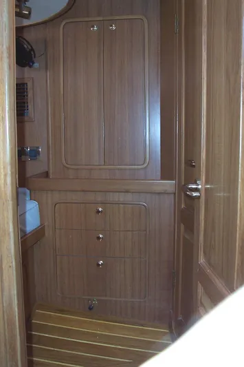 Blue Yacht Photos Pics Wooden interior of 1994 C&C 51 XL C/B yacht, featuring cabinets and striped flooring.