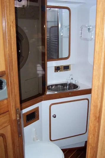 Blue Yacht Photos Pics Compact bathroom in a 1994 C&C 51 XL C/B yacht with wooden accents and stainless steel sink.