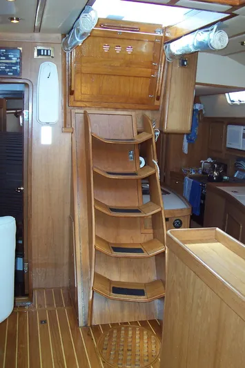 Blue Yacht Photos Pics Interior of 1994 C&C 51 XL C/B sailboat with wooden stairs and cabinetry.