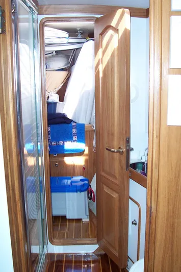 Blue Yacht Photos Pics Interior of 1994 C&C 51 XL C/B sailboat with wooden cabinetry and compact storage.