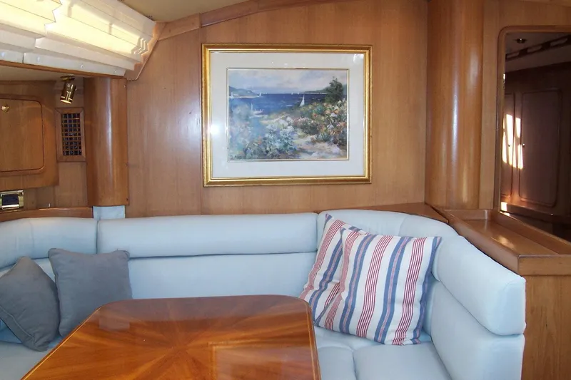 Blue Yacht Photos Pics Interior of 1994 C&C 51 XL C/B yacht with cozy seating and nautical artwork.