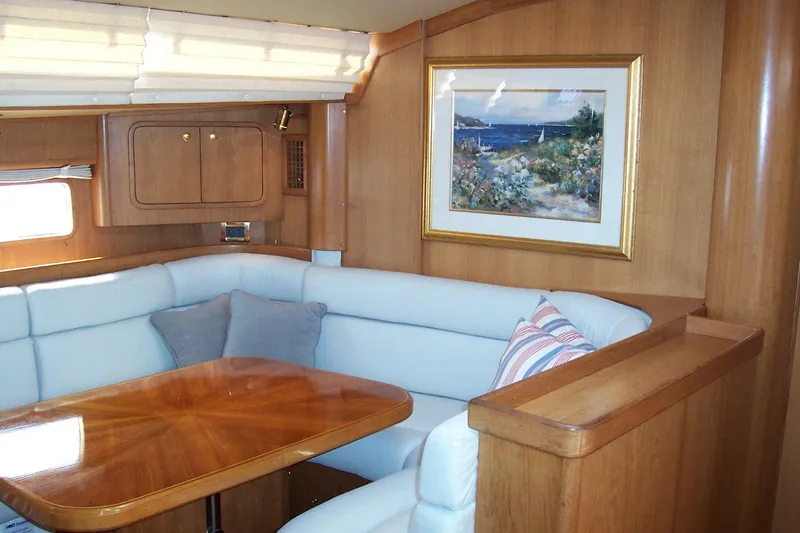 Blue Yacht Photos Pics Luxurious 1994 C&C 51 XL C/B yacht interior with wood finish and cozy seating area.