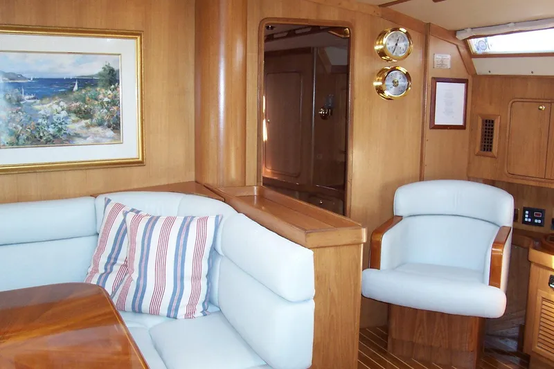 Blue Yacht Photos Pics Luxurious interior of 1994 C&C 51 XL C/B yacht with plush seating and nautical decor.