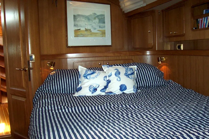 Blue Yacht Photos Pics Cozy cabin interior of 1994 C&C 51 XL C/B yacht with striped bedding and nautical decor.