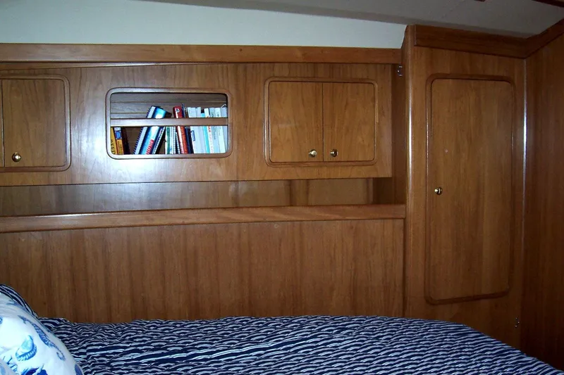Blue Yacht Photos Pics Wooden cabin interior with bookshelves and bed in 1994 C&C 51 XL C/B yacht.