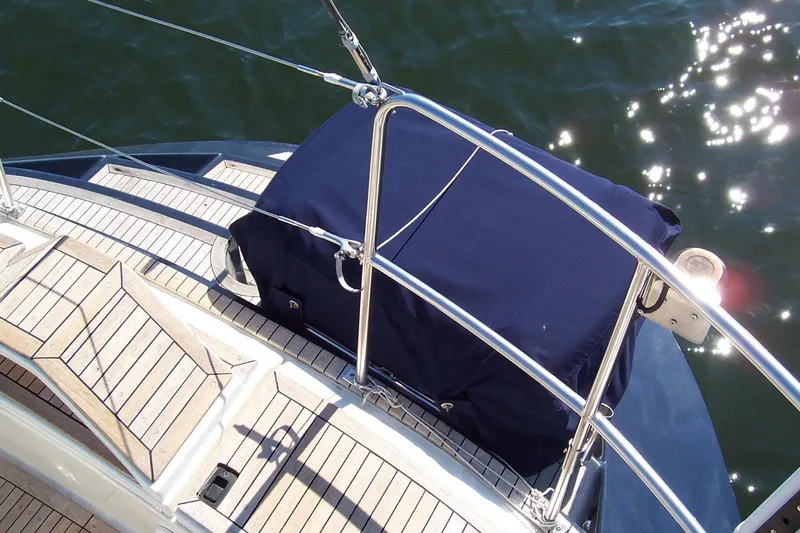 Blue Yacht Photos Pics Sailboat deck of 1994 C&C 51 XL C/B with covered equipment, sunlit water background.