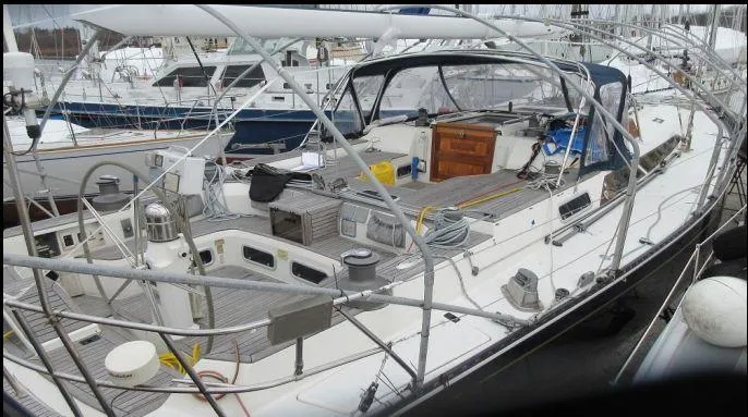 Blue Yacht Photos Pics Sailboat docked in marina, 1994 C&C 51 XL C/B model, featuring spacious deck and cockpit.