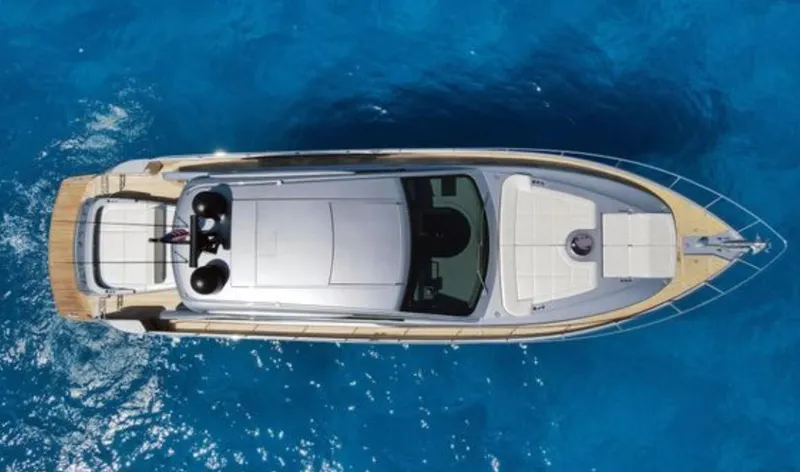 Our Trade Yacht Photos Pics Top view of a 2022 Pershing 6X yacht on clear blue water.