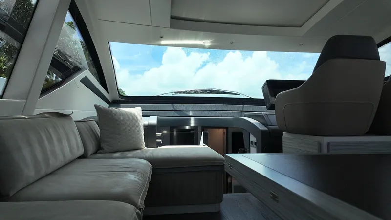 Our Trade Yacht Photos Pics Luxurious interior of 2022 Pershing 6X yacht with modern seating and panoramic windows.