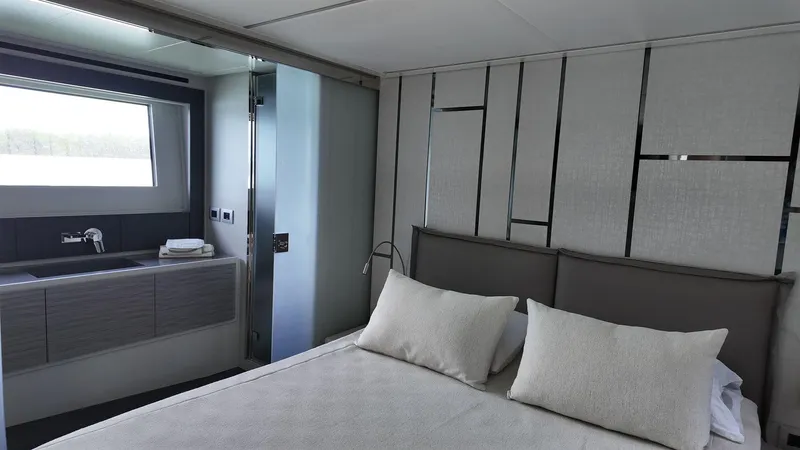 Our Trade Yacht Photos Pics Luxurious bedroom interior of 2022 Pershing 6X yacht with modern design and elegant decor.