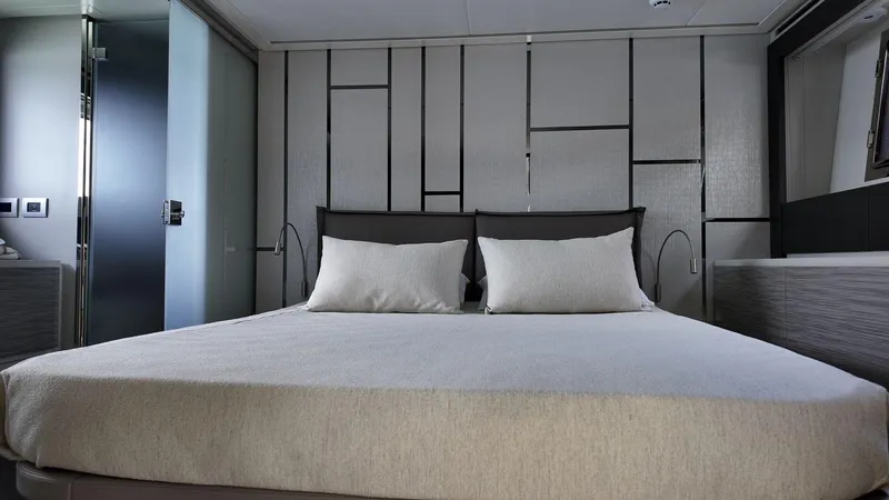 Our Trade Yacht Photos Pics Luxurious bedroom interior of 2022 Pershing 6X yacht with modern design elements.