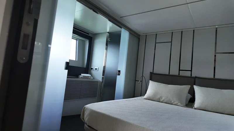Our Trade Yacht Photos Pics Luxurious bedroom interior of 2022 Pershing 6X yacht with modern design and elegant decor.