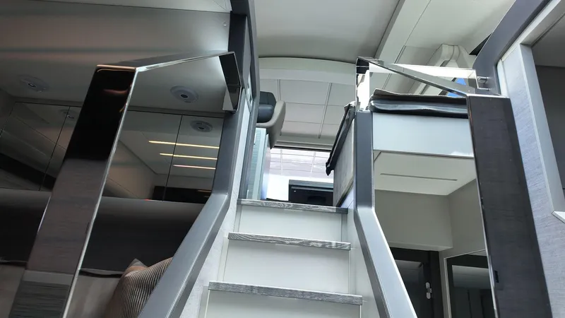 Our Trade Yacht Photos Pics Interior staircase of 2022 Pershing 6X yacht, featuring modern design and sleek finishes.