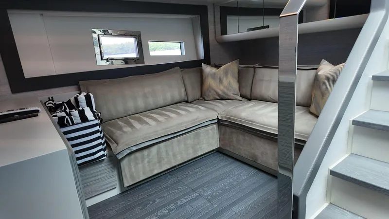 Our Trade Yacht Photos Pics Luxurious interior of 2022 Pershing 6X yacht with plush seating and modern design.