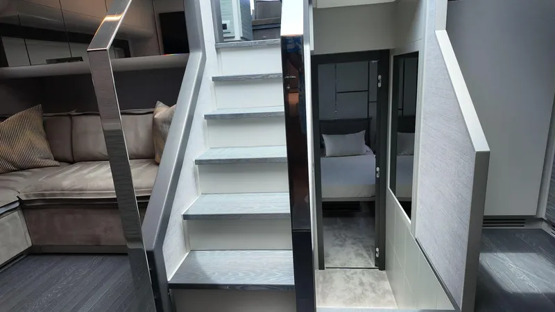 Our Trade Yacht Photos Pics Interior of 2022 Pershing 6X yacht with modern staircase and luxurious seating area.