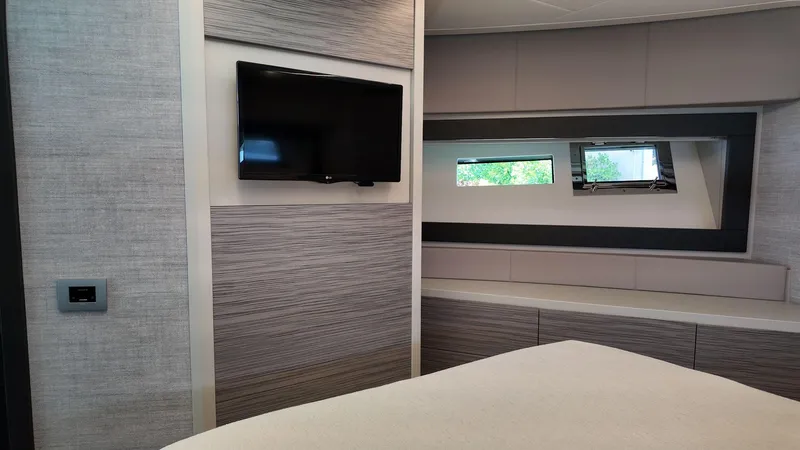 Our Trade Yacht Photos Pics Interior of 2022 Pershing 6X yacht with modern TV and sleek window design.