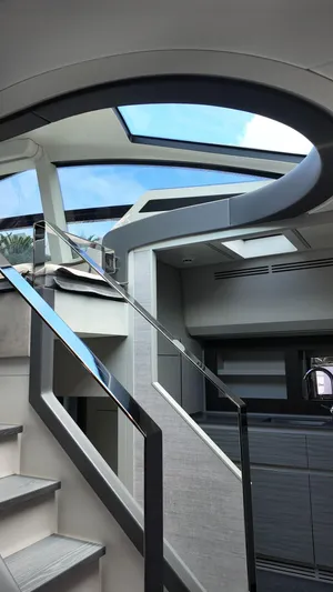 Our Trade Yacht Photos Pics Interior view of 2022 Pershing 6X yacht with modern staircase and skylight.