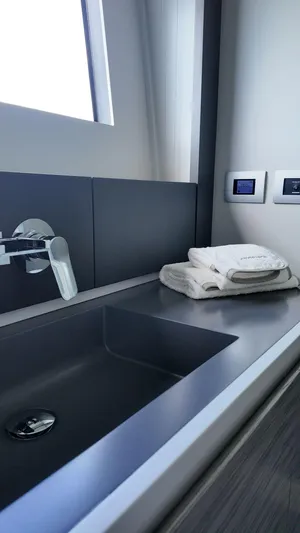 Our Trade Yacht Photos Pics Modern bathroom sink in 2022 Pershing 6X yacht, featuring sleek design and luxury amenities.