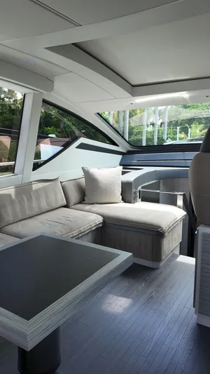 Our Trade Yacht Photos Pics Luxurious interior of 2022 Pershing 6X yacht with modern seating and sleek design.